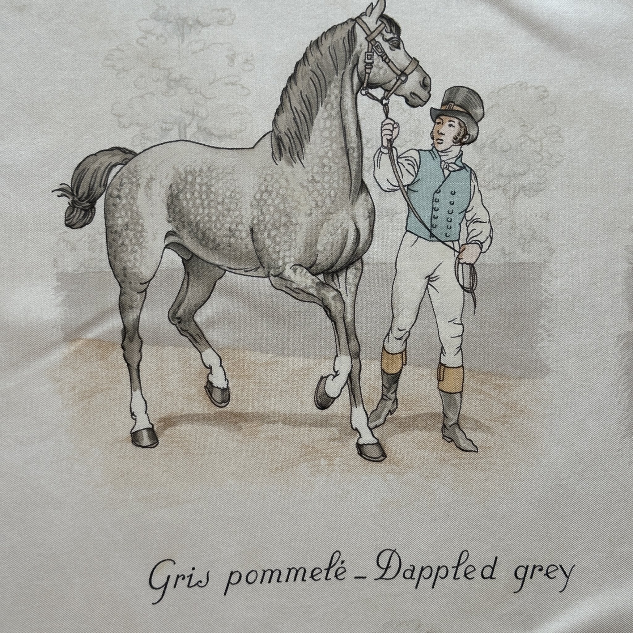 zoom sur un dessin de cheval à la robe gris pommelé au centre du foulard